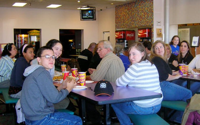 Florida Connections Academy students eating pizza together on a field trip
