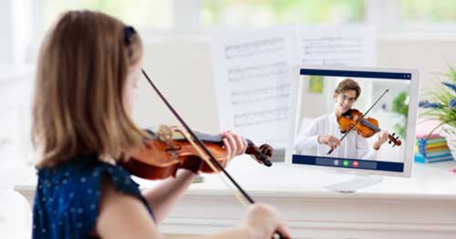 A student learning to play the violin in an online extracurricular class.  